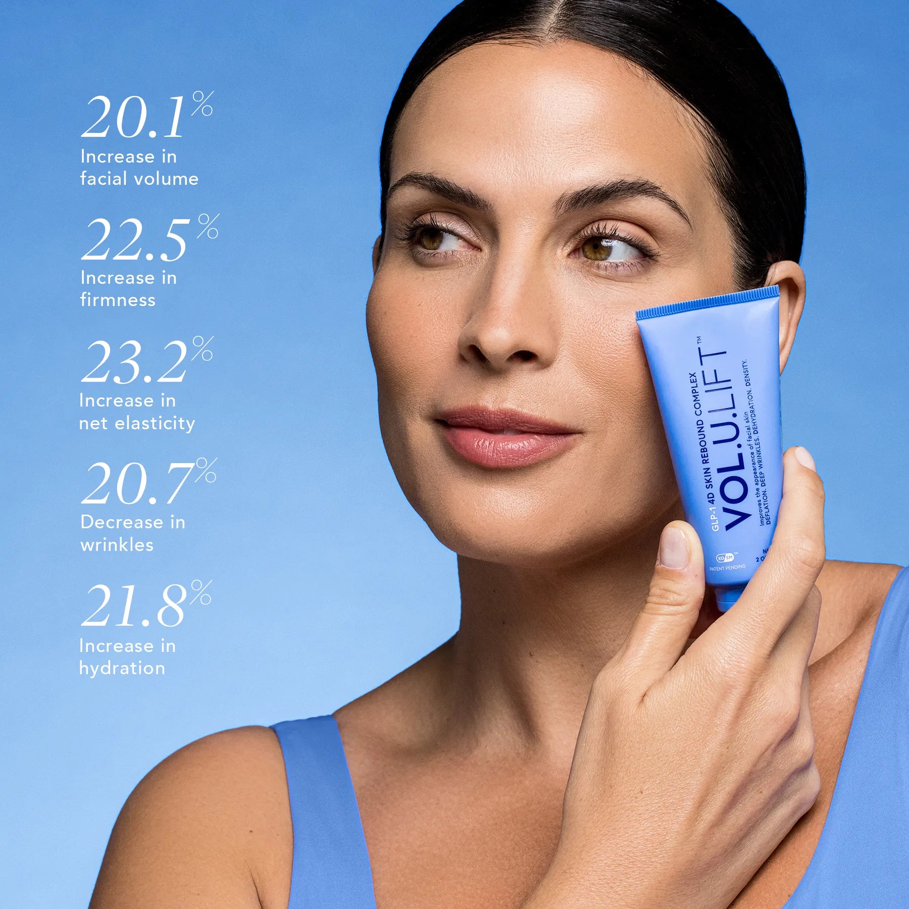 Woman holding a VoluLift product with skincare benefits on a blue background