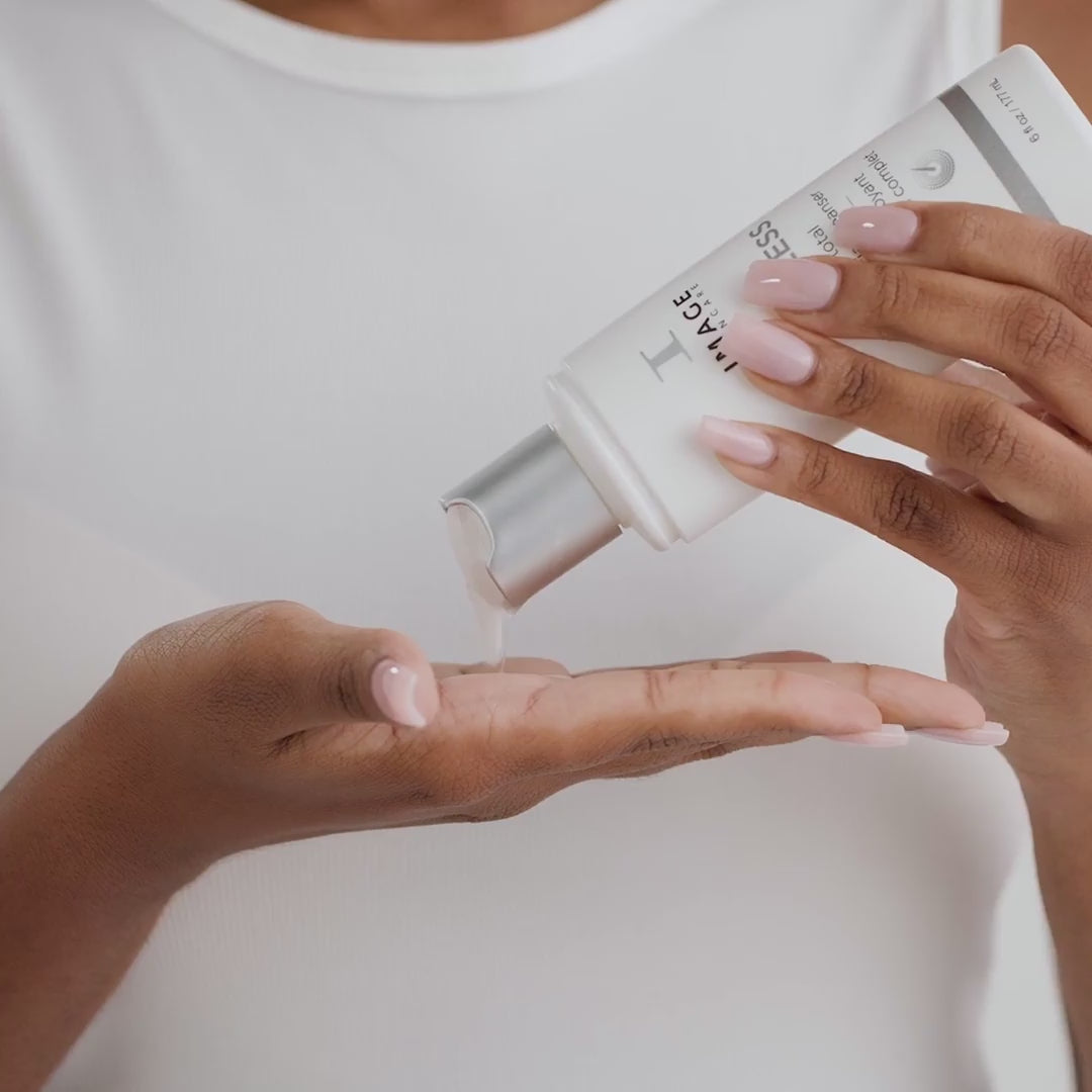 video of model applying cleanser to face and wiping off