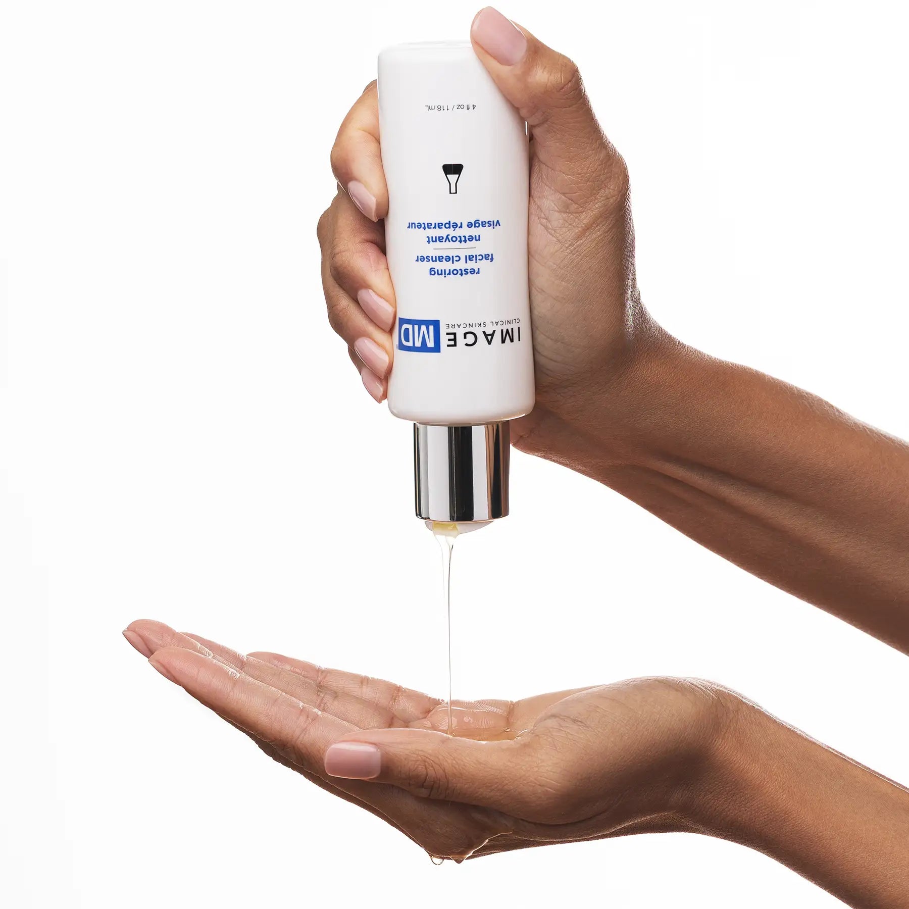 Hand holding a skincare product labeled 'IMAGE MD facial cleanser' with another hand catching the liquid.