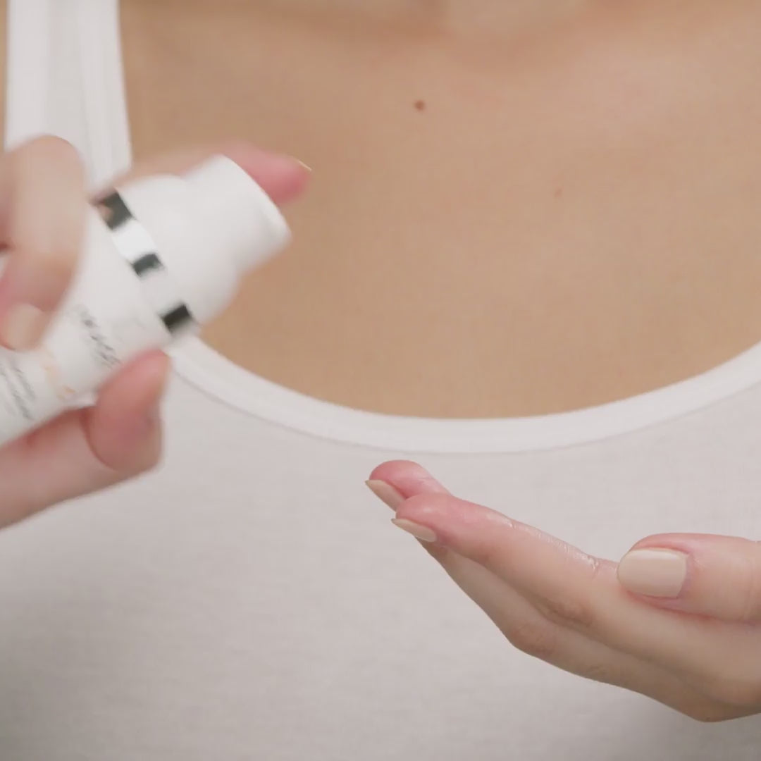 model applying moisturizer to face