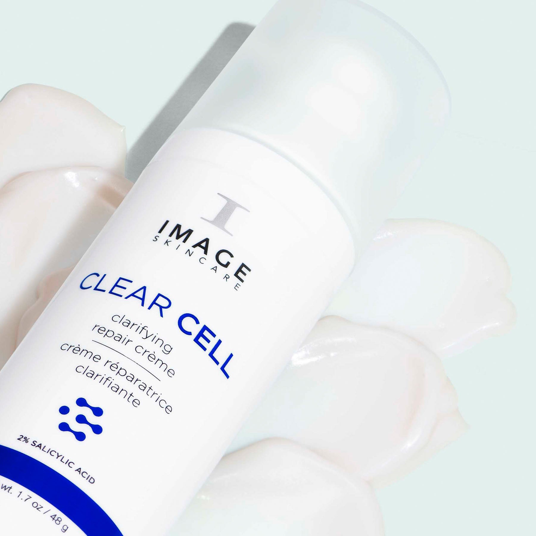 CLEAR CELL clarifying repair crème bottle laying on texture swatch