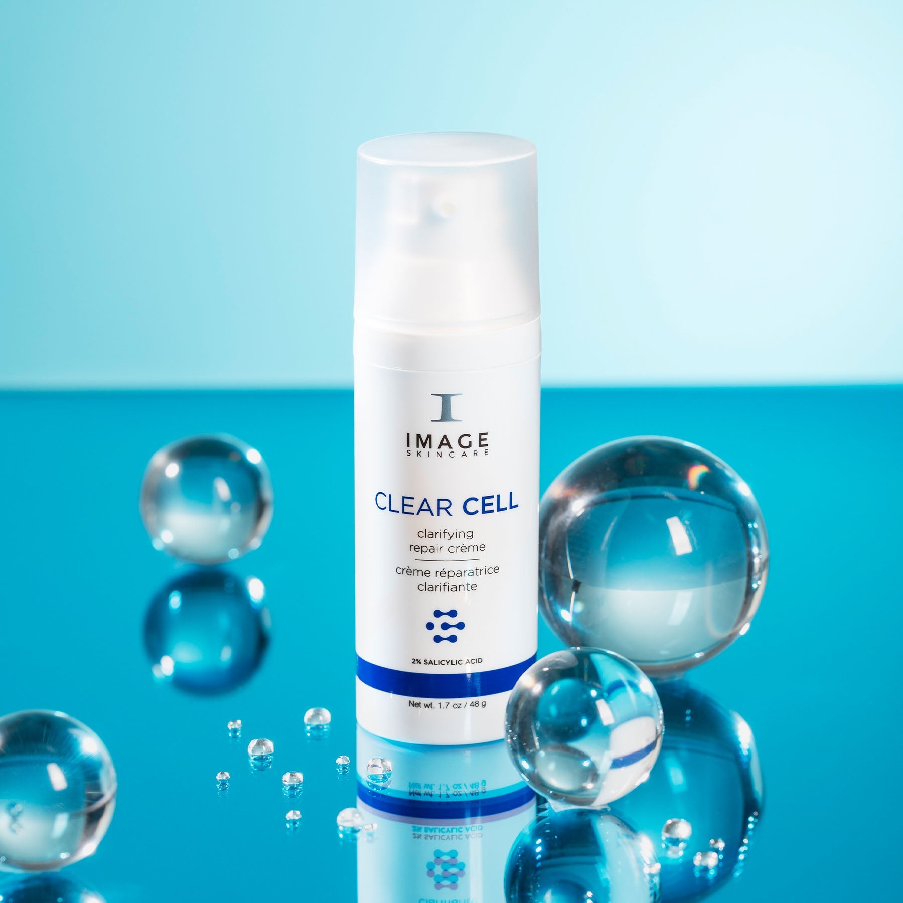 CLEAR CELL clarifying repair crème bottle next to bubbles on blue background