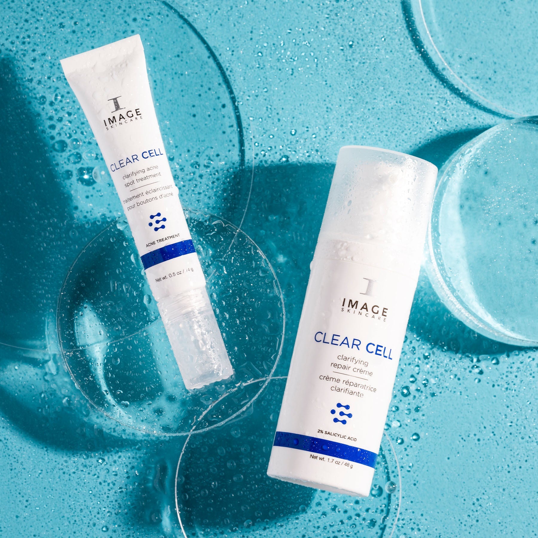 CLEAR CELL clarifying repair crème and acne spot treatment on blue background with bubbles