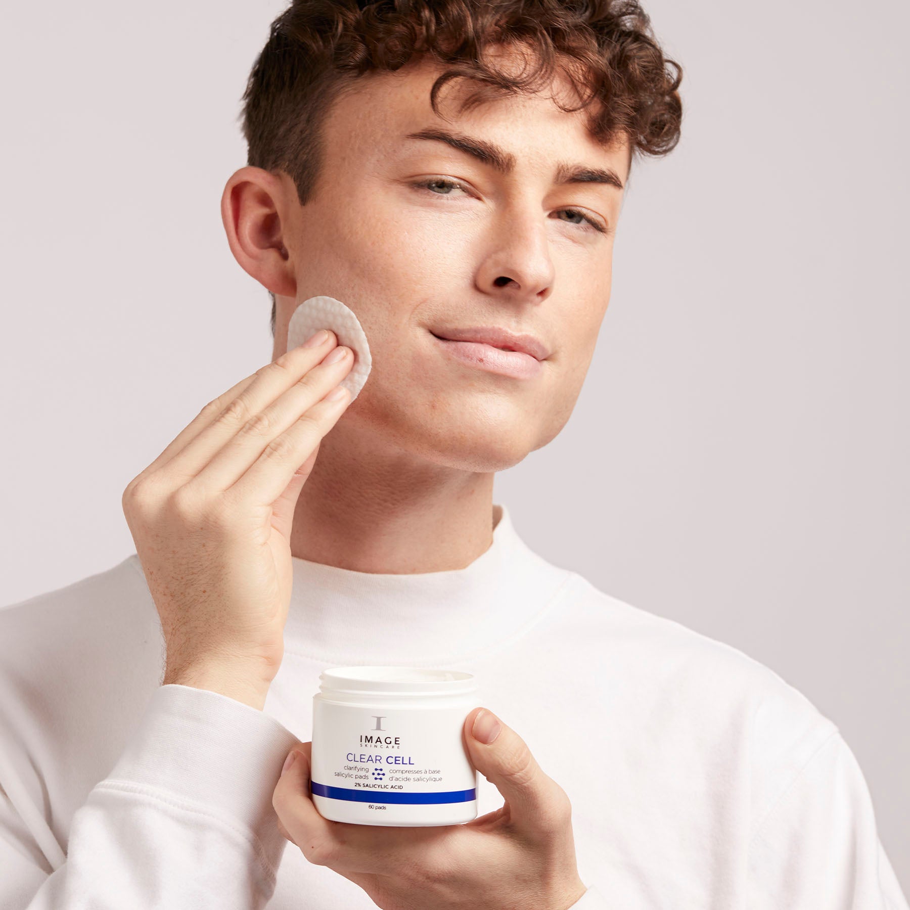 male model using salicylic pads on face