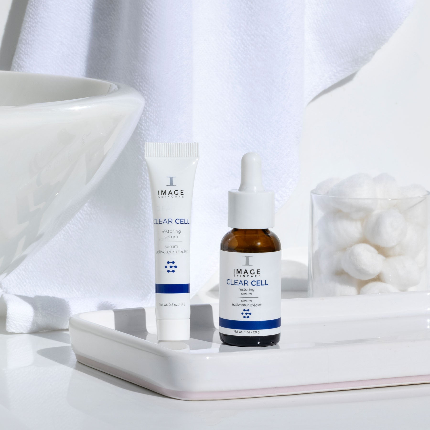 clear cell restoring serum retail and travel size on bathroom counter
