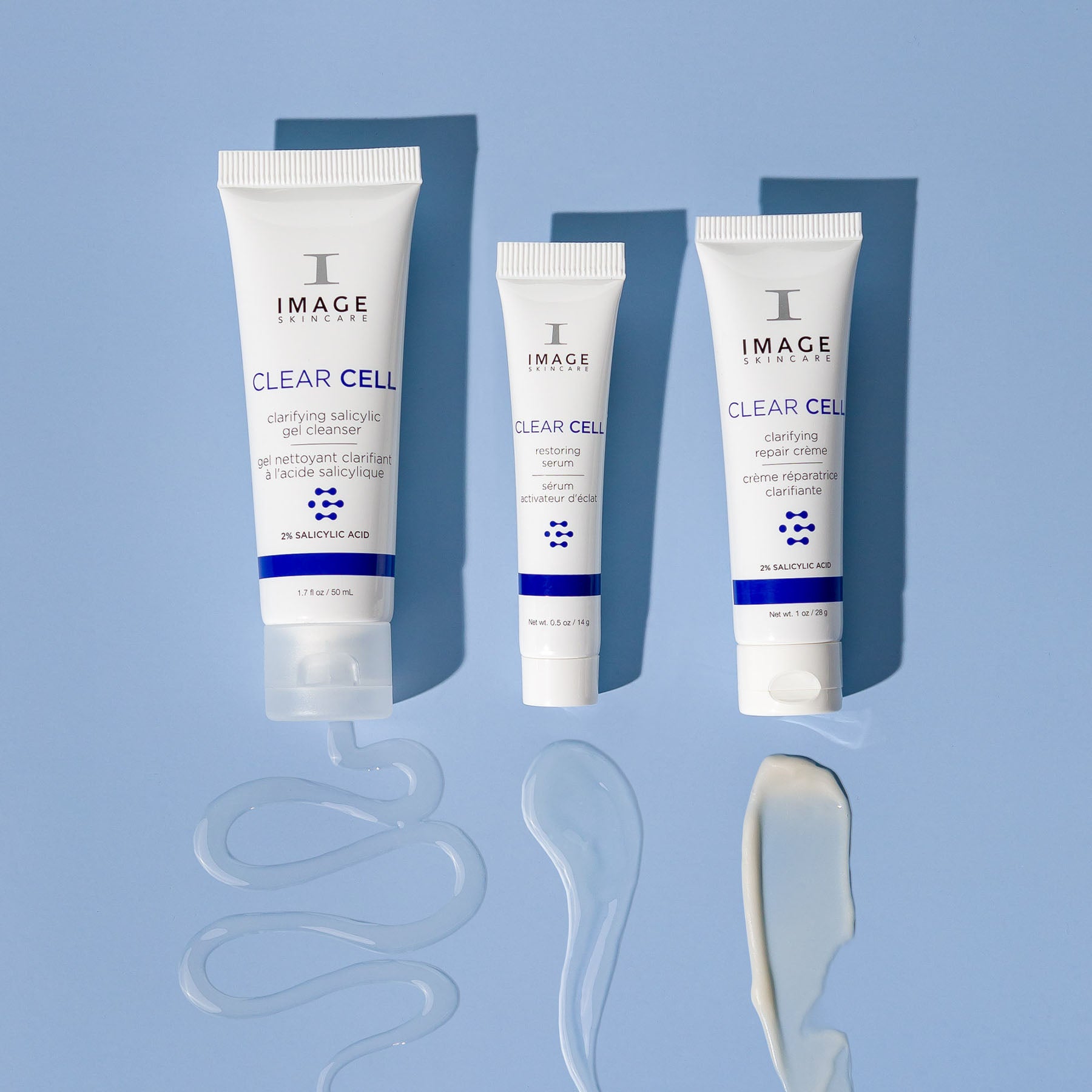 clear cell salicylic cleanser, restoring serum , and repair creme travel size products on blue background with product swatches below each product