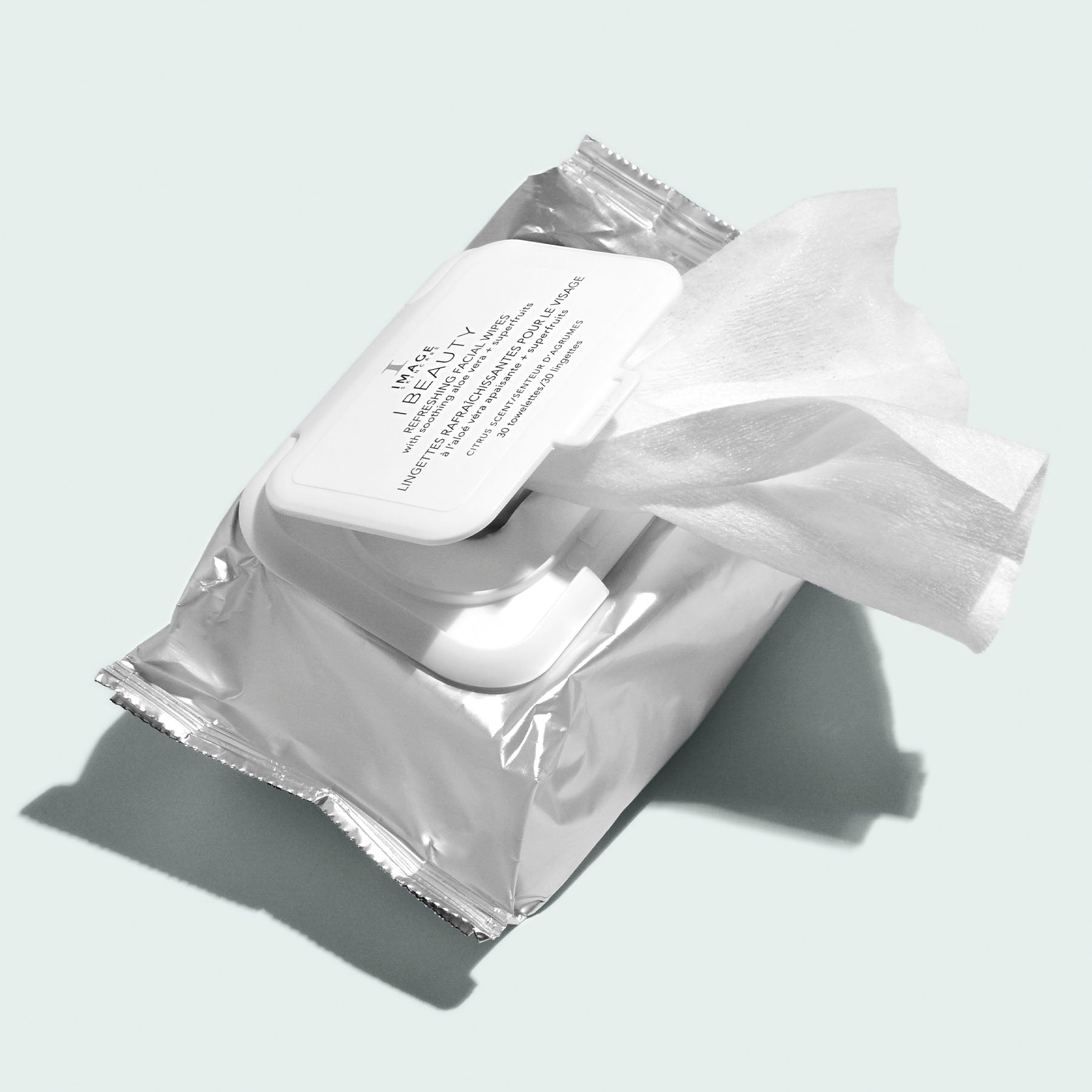 Package of I MAGE Beauty refreshing facial wipes opened and dispensing wipe on a white background