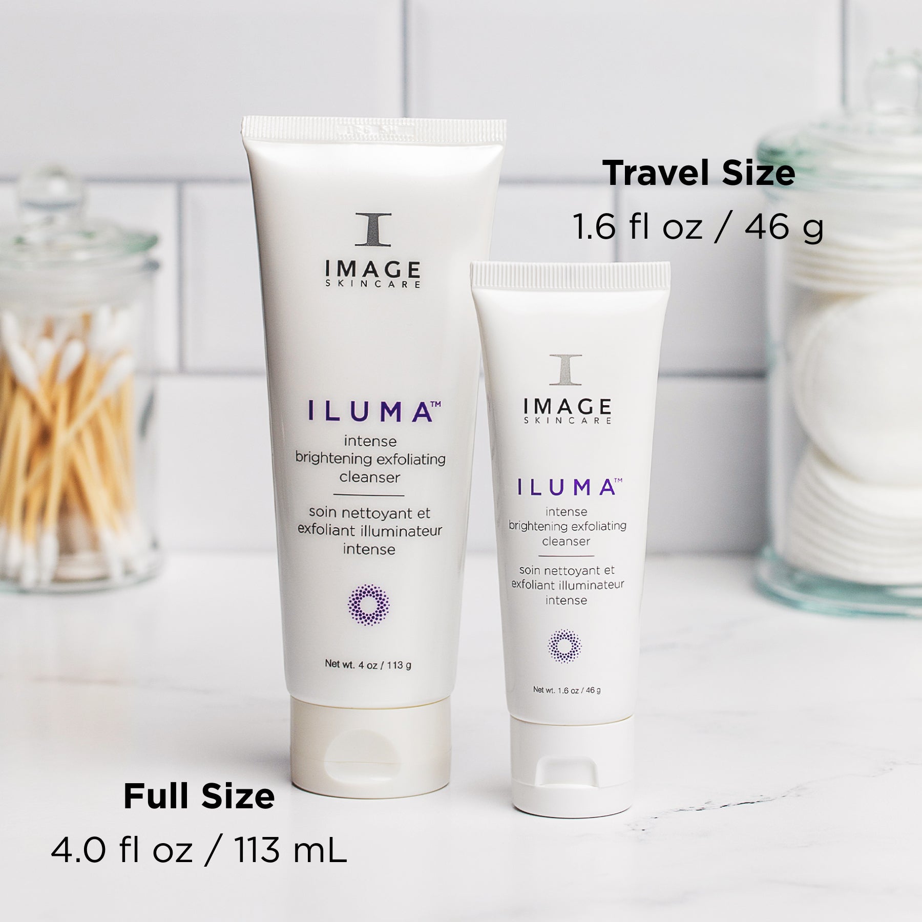 ILUMA exfoliating cleanser retail and travel size tube on a bathroom counter