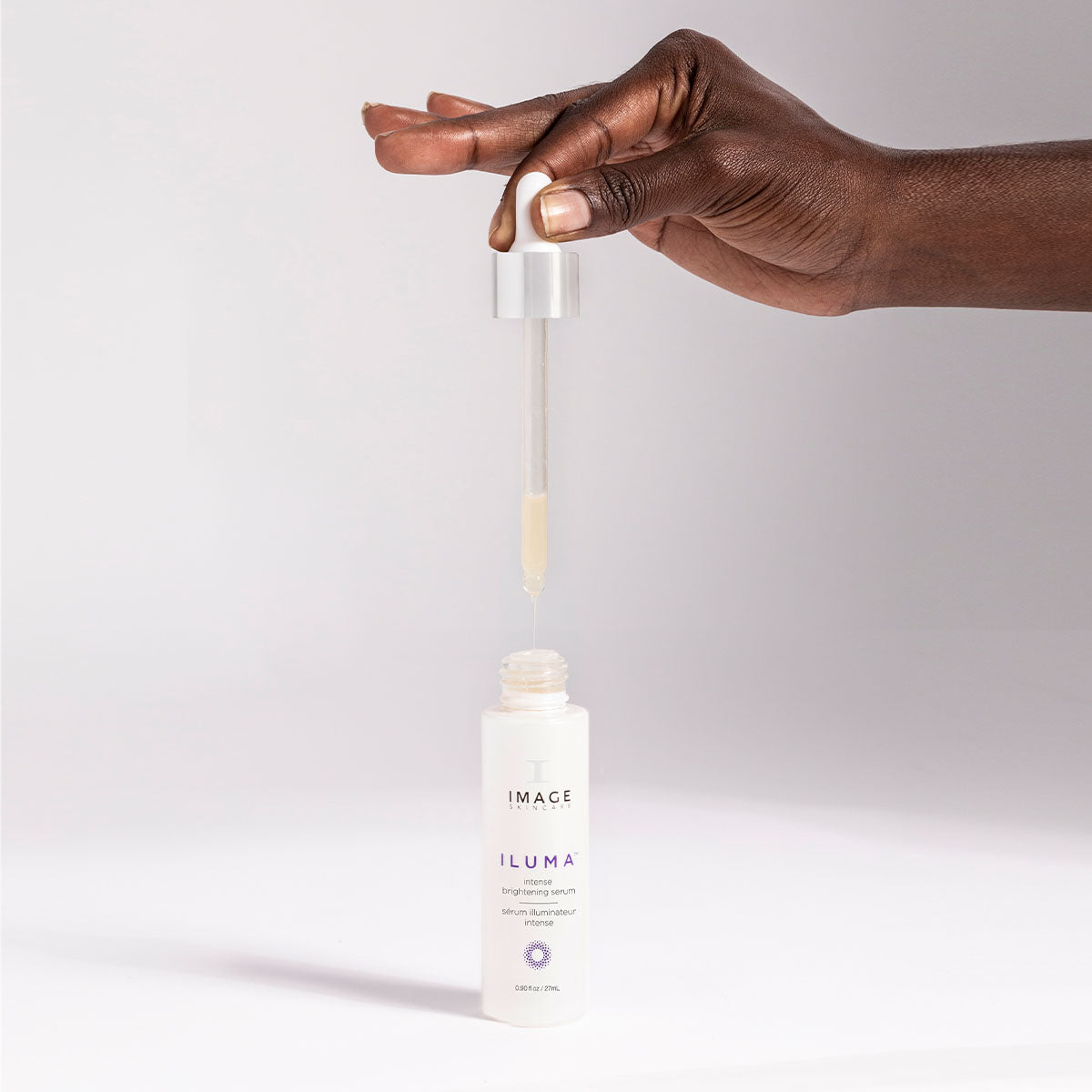 model holding serum applicator above open bottle 