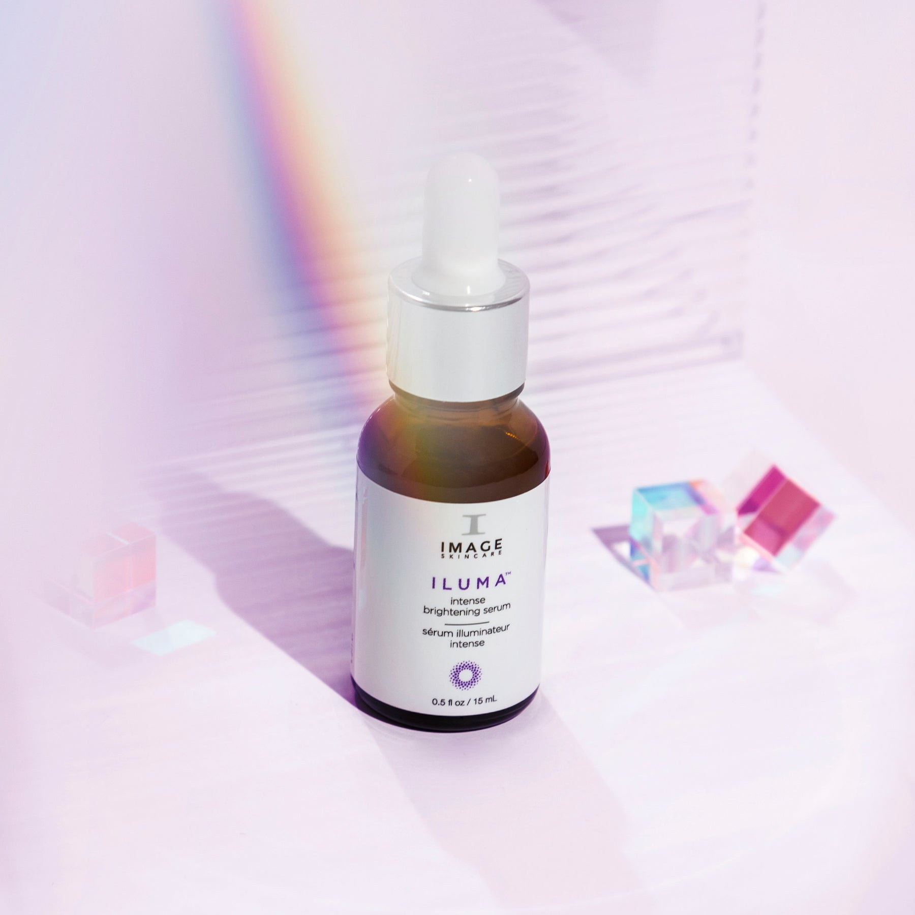 travel size iluma brightening serum on light purple background