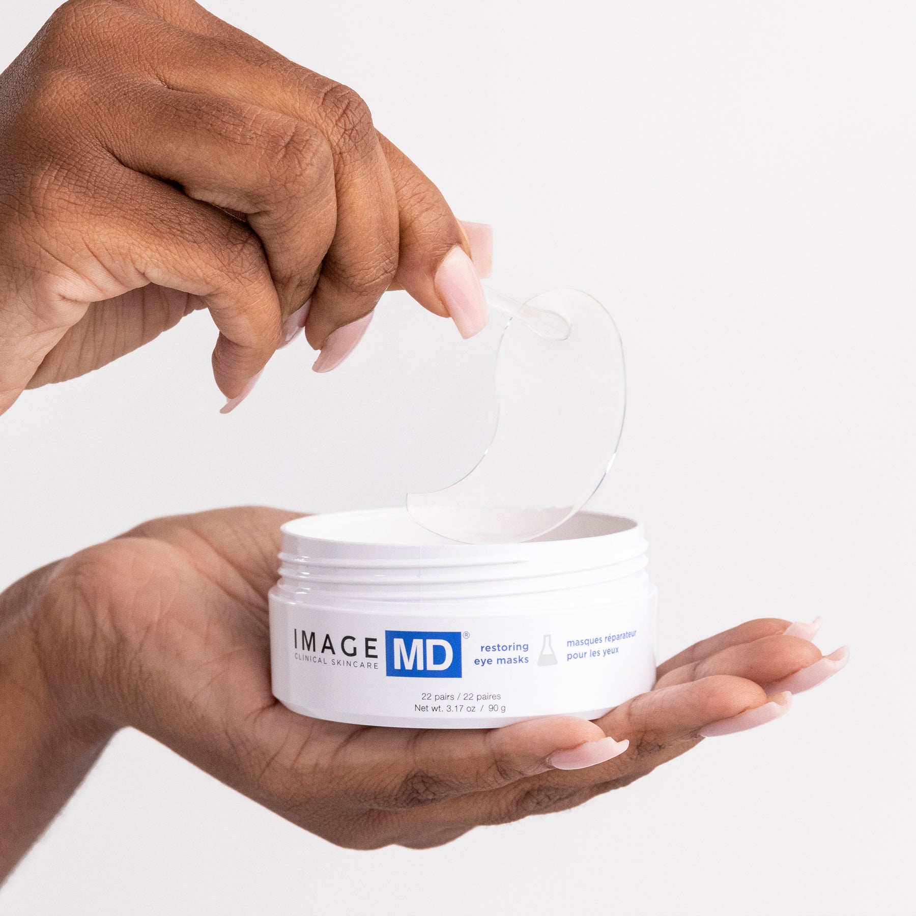 A woman taking an eye mask out of the eye mask jar