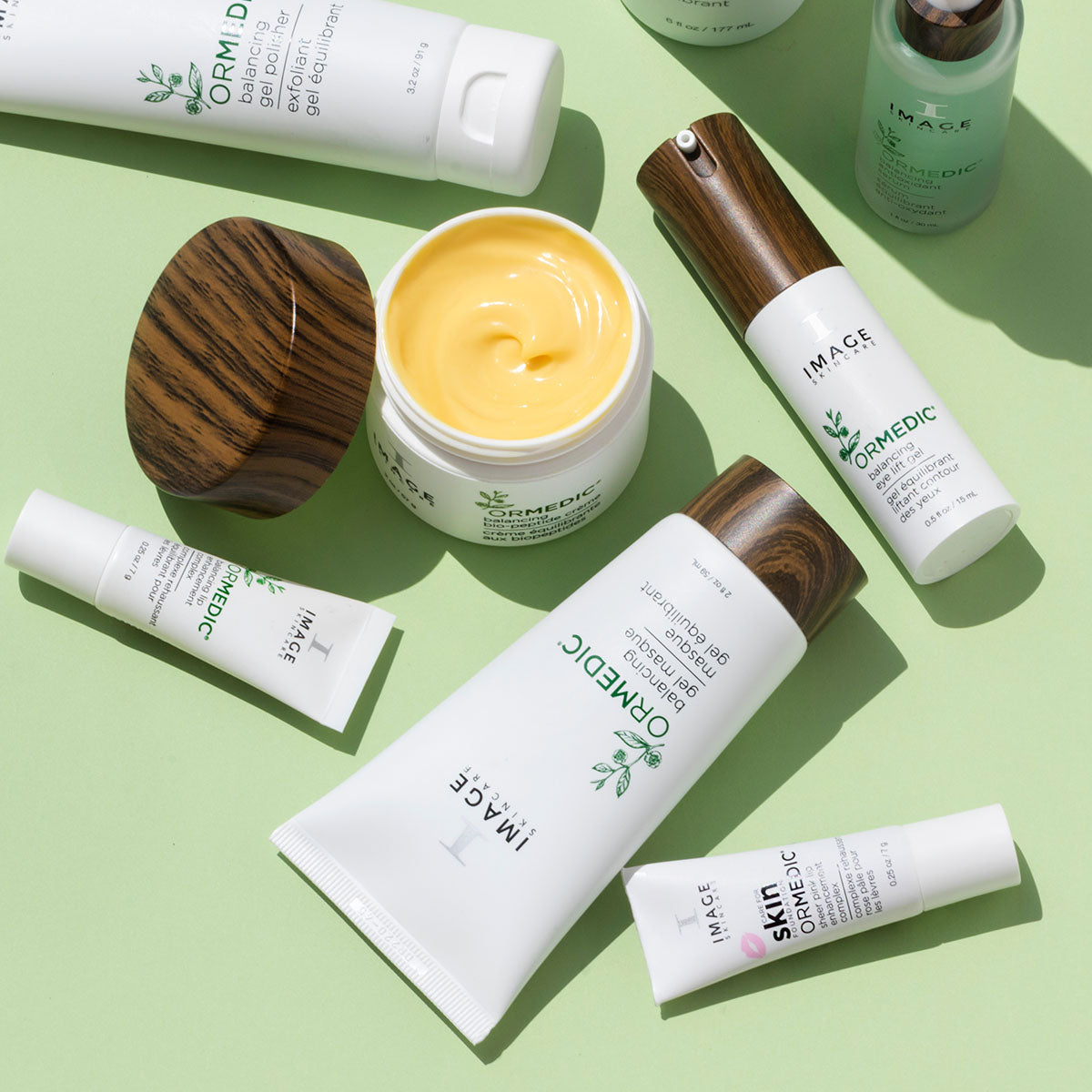 Full ormedic product collection with opened biopeptide creme container in the middle on a light green background