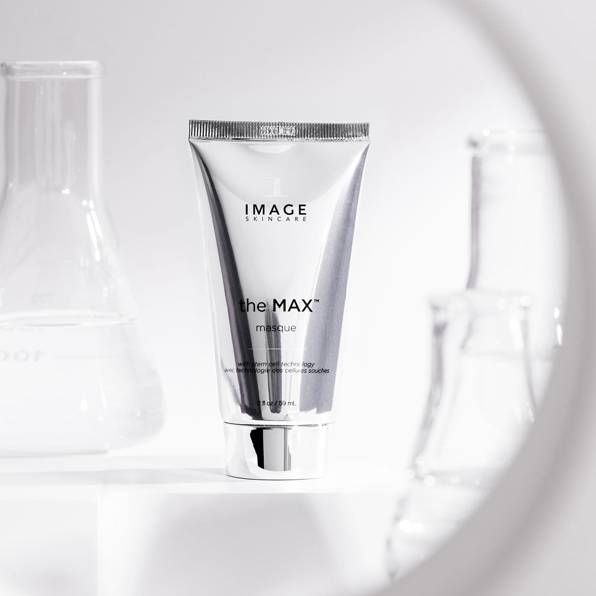 Max masque tube on white counter next to beaker