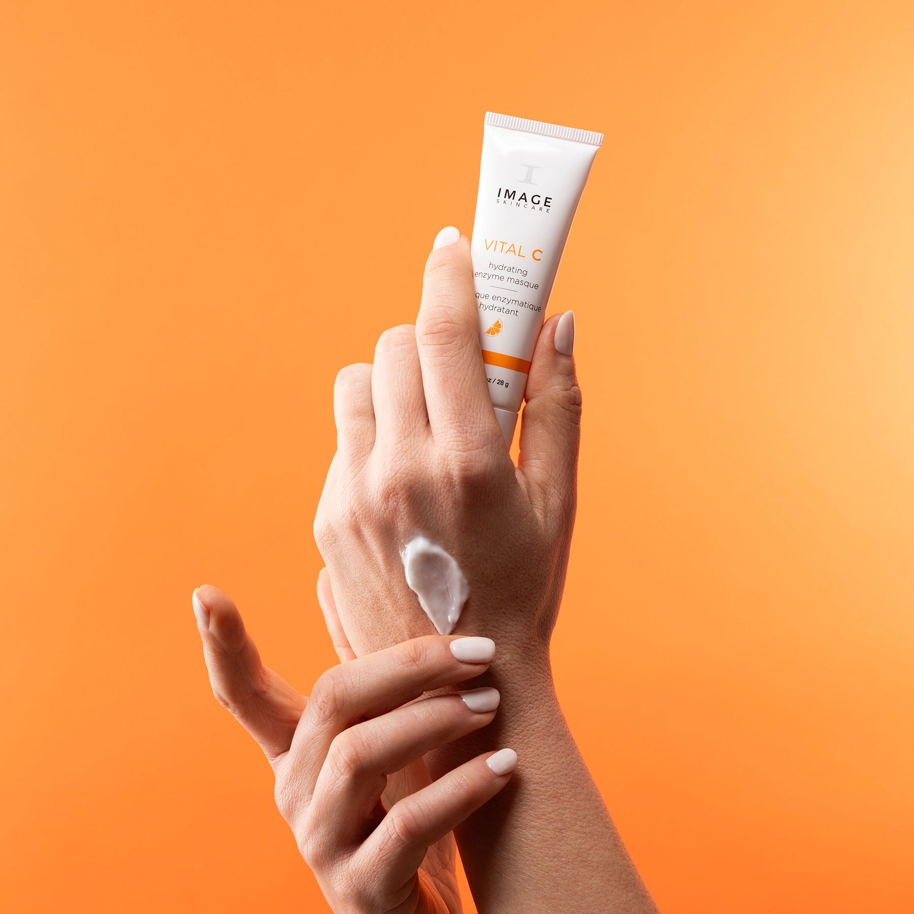 hand with serum swatch holding product tube