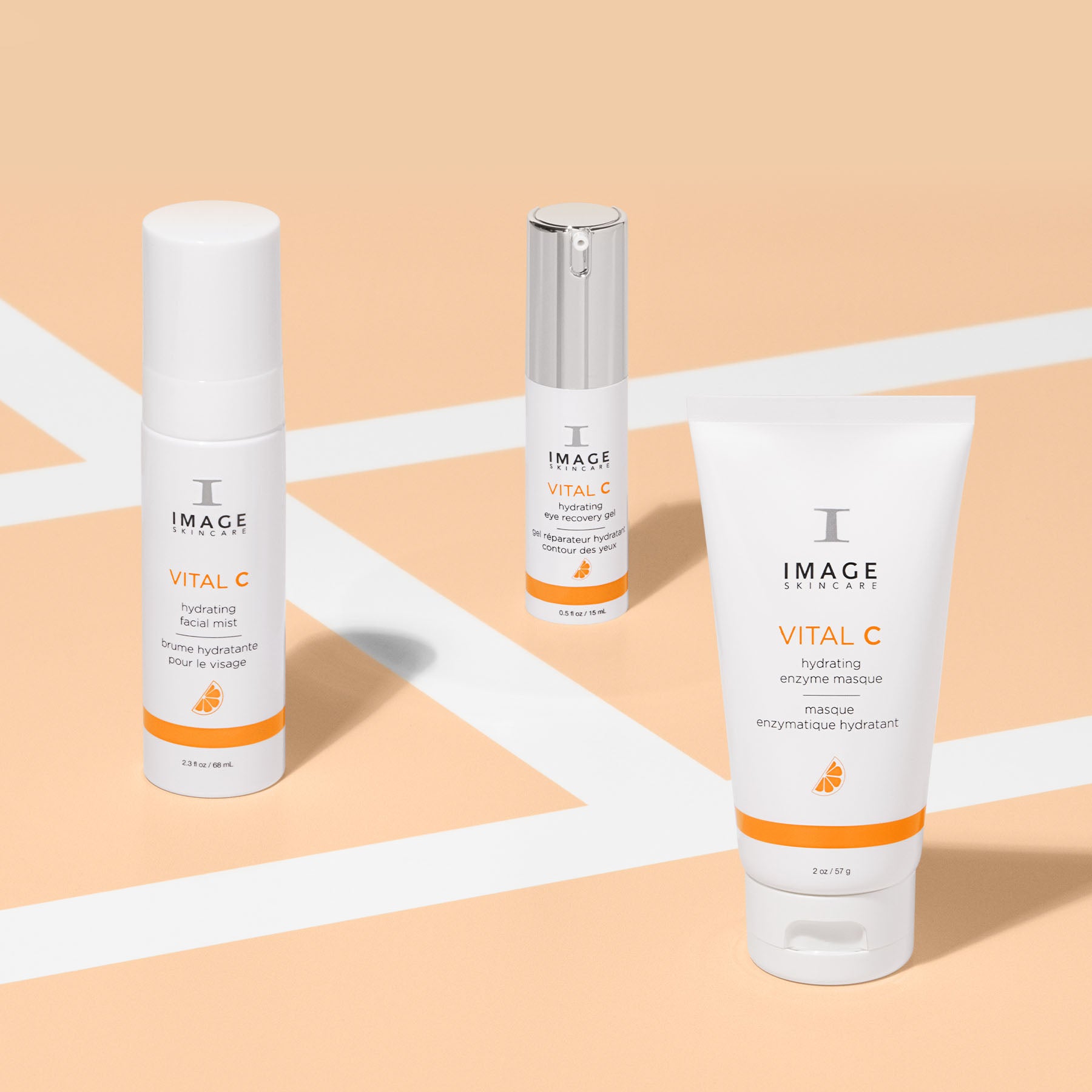 vital c facial mist, eye recovery gel, and enzyme masque on an orange and white background