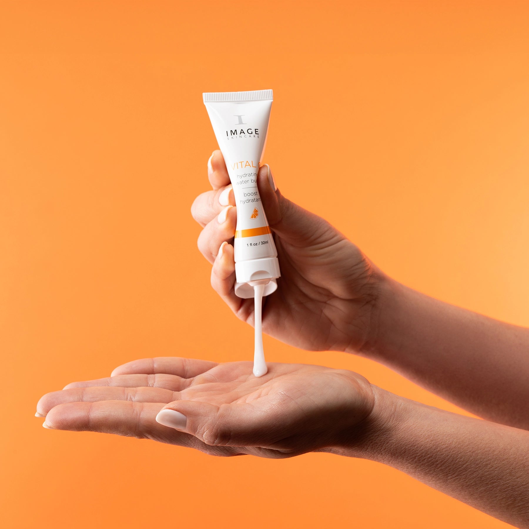 model hand squeezing tube of water burst onto palm