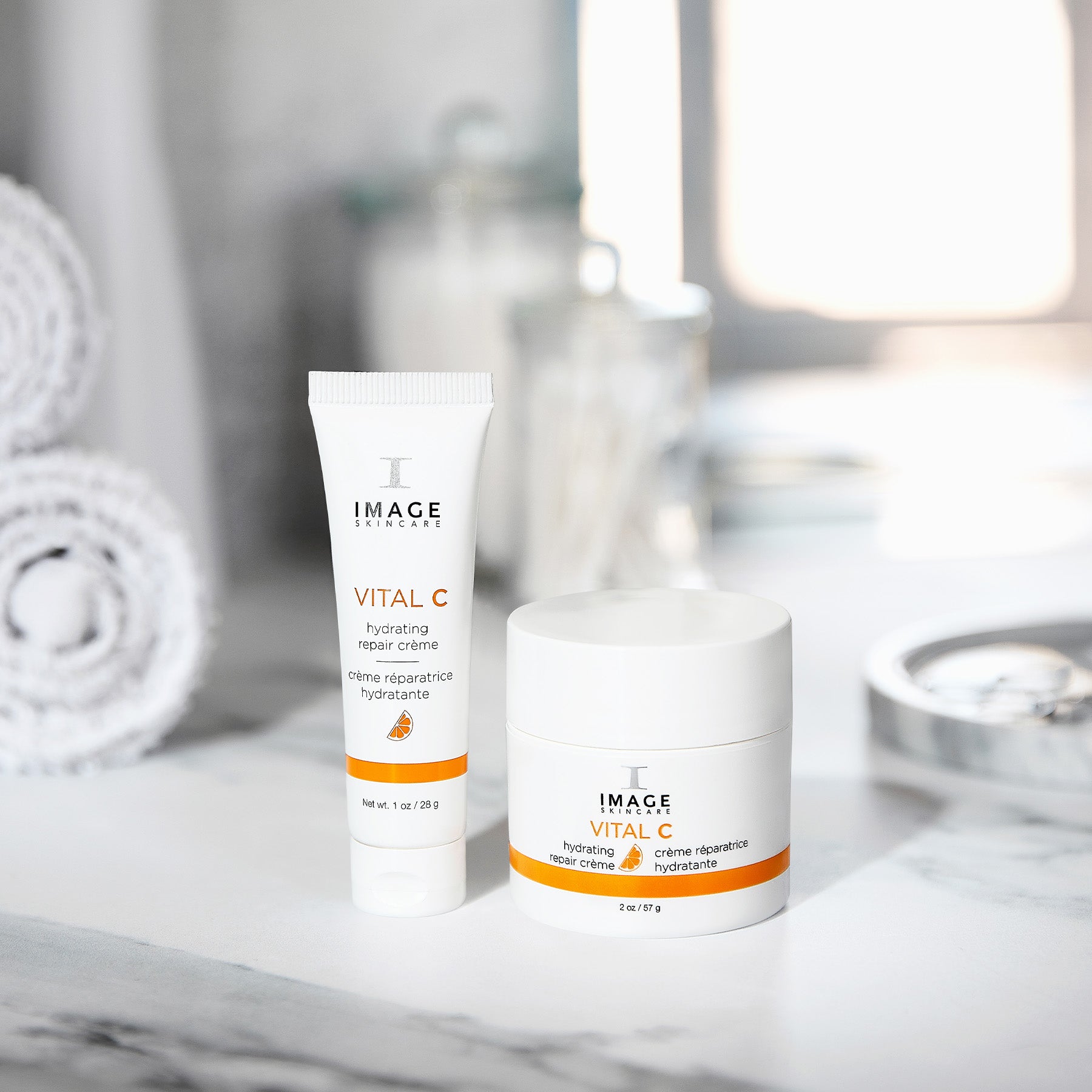 repair creme retail size next to travel size on bathroom counter