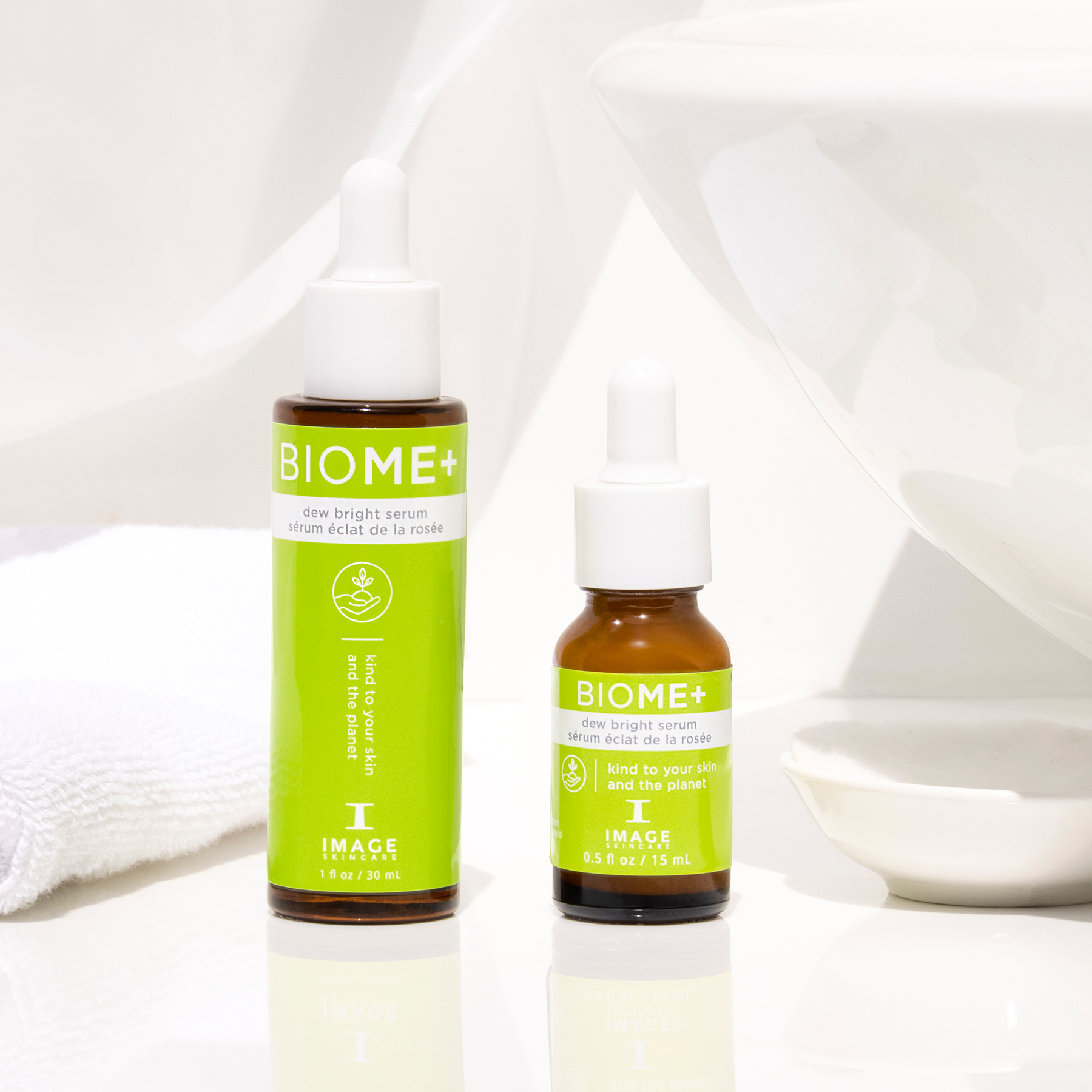 BIOME+ dew bright serum retail and travel size bottles on bathroom counter